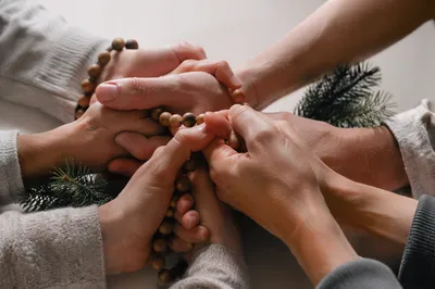 Prayer Circle Hands with Evergreen Sprigs