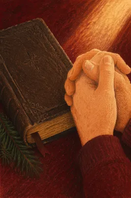 Praying Hands Beside Bible with Evergreen Sprig