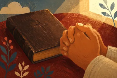 Praying Hands Beside Leather Bible