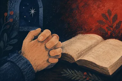 Praying Hands Beside Bible with Evergreen Sprig