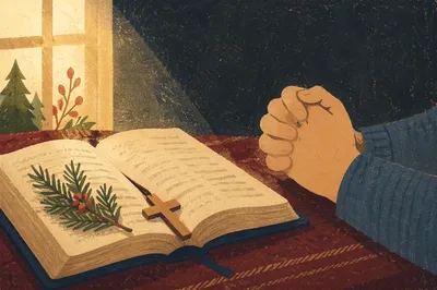 Praying Hands Beside Open Bible