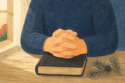 Praying Hands on Bible with Evergreen Sprig