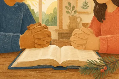 Praying Hands Over Bible with Evergreen Sprig