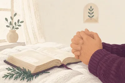 Praying Hands Beside Bible and Evergreen Sprig