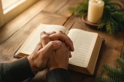 Praying Hands Over Open Bible Devotion