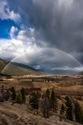 Rainbow After Storm Over Mountain Valley