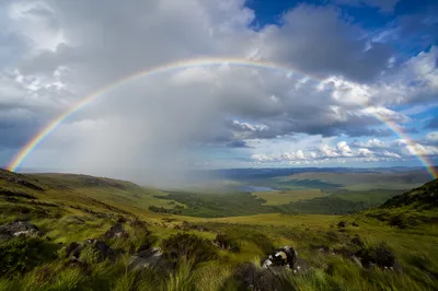 Vivid Rainbow Over Stormy Green Valley