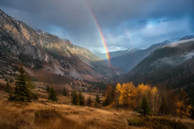 Rainbow Over Peaceful Mountain Valley