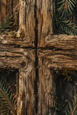Rugged Wooden Cross with Evergreen Texture