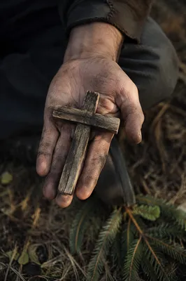 Rugged Wooden Cross in Open Palm