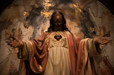 Sacred Heart Statue in Warm Chapel Light