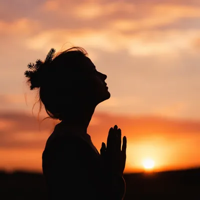 Praying Silhouette Beneath Golden Sunset Sky