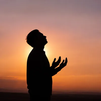 Silhouette Prayer at Peaceful Sunset