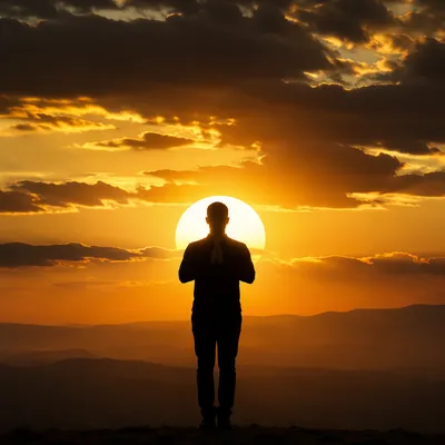 Praying Silhouette Against Golden Sunset