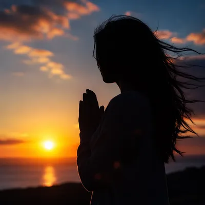 Praying Silhouette at Hopeful Sunset
