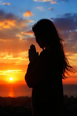 Prayer Silhouette Against Golden Sunset Sky