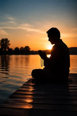 Silhouette Praying on Dock at Sunset