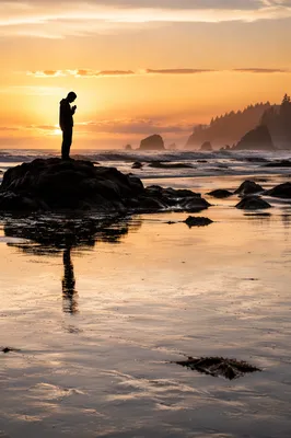 Silhouette Prayer on Coastal Sunset Shore