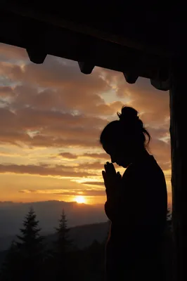 Silhouetted Prayer Beneath Sunset Sky