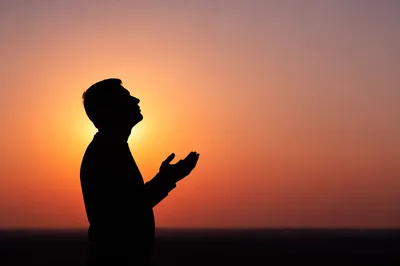 Peaceful Prayer Silhouette at Sunset