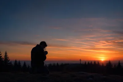 Silhouetted Prayer on Evergreen Sunset Hill