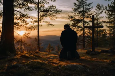 Silhouetted Prayer Among Pines at Sunset