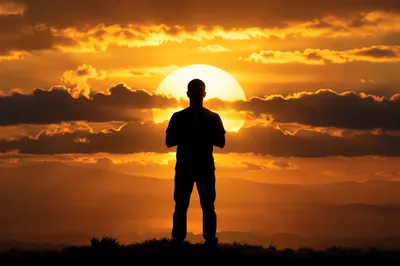 Praying Silhouette Beneath Golden Sunset