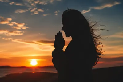 Praying Silhouette at Golden Sunset