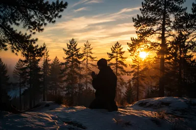 Silhouetted Prayer on Evergreen Hill at Sunset