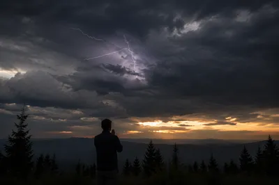 Silhouetted Prayer Beneath Stormy Sunset Sky