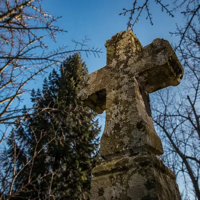 Weathered Stone Cross in Winter Cemetery