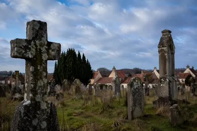 Weathered Stone Cross in Old Rural Cemetery