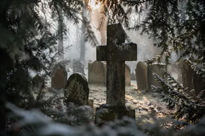Weathered Stone Cross in Winter Cemetery