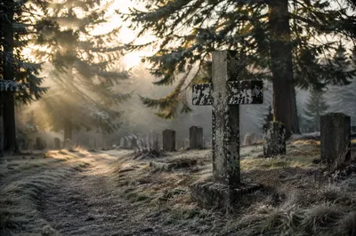 Weathered Stone Cross in Winter Cemetery