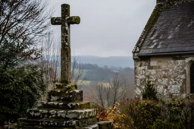 Mossy Stone Cross in Rural Churchyard