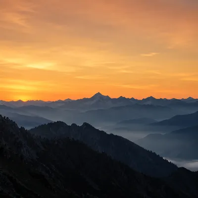Golden Sunrise Over Hazy Mountain Range