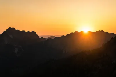 Golden Sunrise Over Evergreen Mountain Peaks