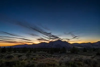 Golden Sunrise Over Evergreen Mountain Range