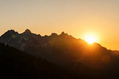 Golden Sunrise Over Evergreen Mountain Range