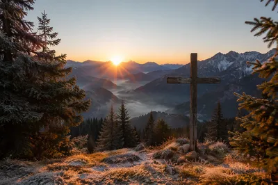Golden Sunrise Cross on Evergreen Mountain Ridge