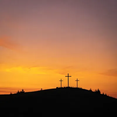 Three Crosses on Hill at Sunset