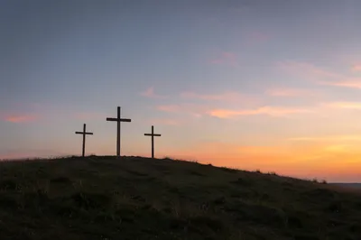 Three Wooden Crosses at Peaceful Sunset