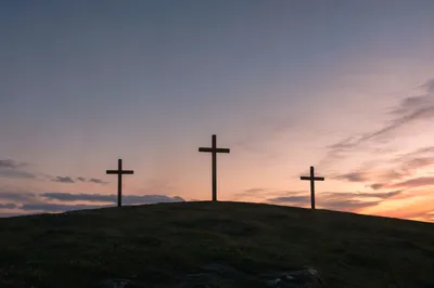 Three Crosses on a Sunset Hill