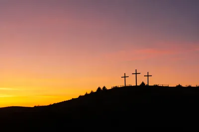 Three Crosses on Hill at Sunset