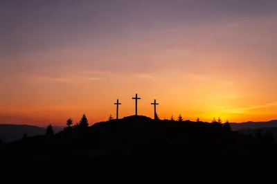Three Crosses Silhouetted on Sunset Hill