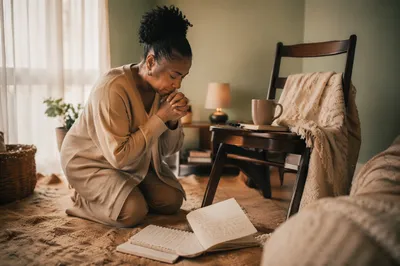 Woman Praying in Cozy Home Corner