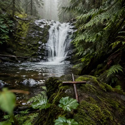 Evergreen Waterfall with Quiet Wooden Cross