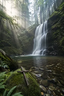 Misty Evergreen Waterfall with Wooden Cross