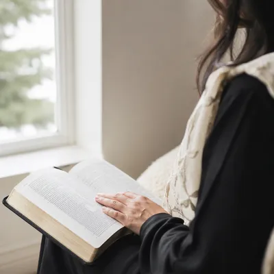 Woman Reading Bible by Bright Window