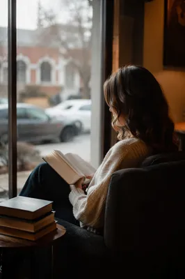 Woman Reading Bible by Cafe Window